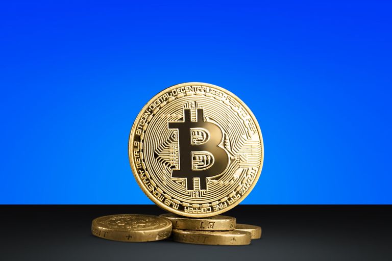 Bitcoin in front of a blue background